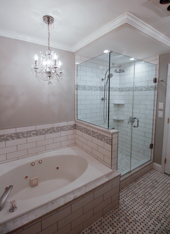 This is an example of a mid-sized traditional master bathroom in New York with flat-panel cabinets, grey cabinets, a drop-in tub, a corner shower, an urinal, white tile, ceramic tile, grey walls, mosaic tile floors, an undermount sink, marble benchtops, white floor and a hinged shower door.