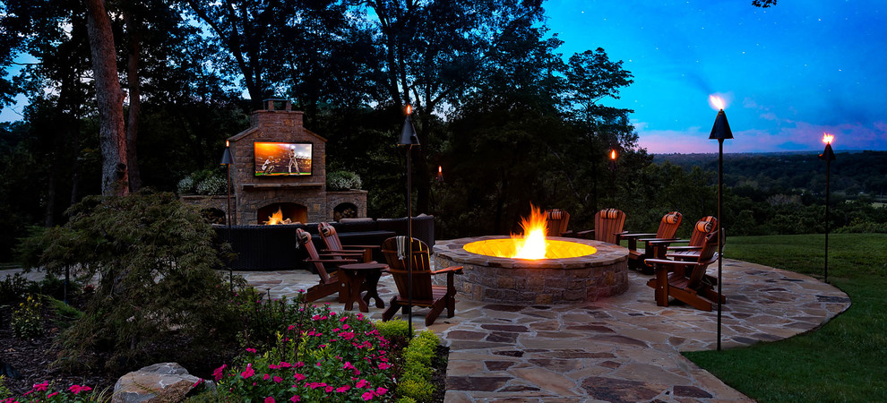 Inspiration for a large transitional partial sun backyard stone landscaping with a fire pit for summer.