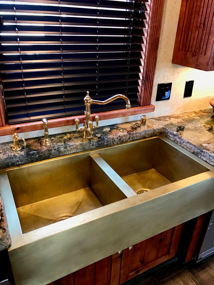 Inspiration for a country open plan kitchen in Los Angeles with a double-bowl sink, glass-front cabinets, dark wood cabinets, granite benchtops and with island.