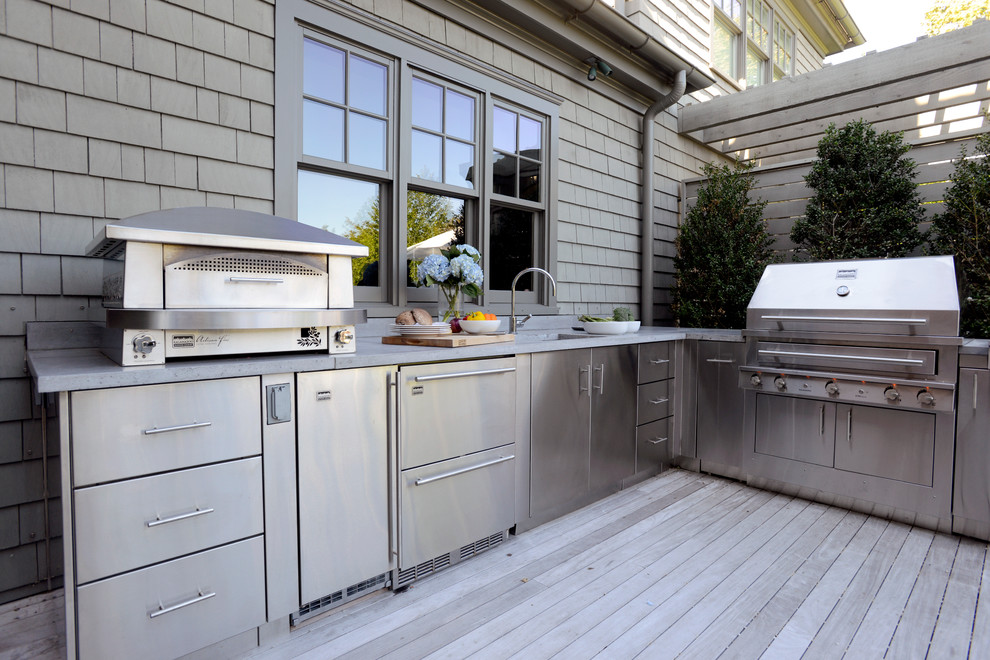 Large beach style backyard deck in Chicago with an outdoor kitchen.