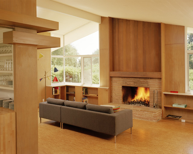 Design ideas for a mid-sized modern open concept living room in San Francisco with cork floors, a standard fireplace, a brick fireplace surround and no tv.
