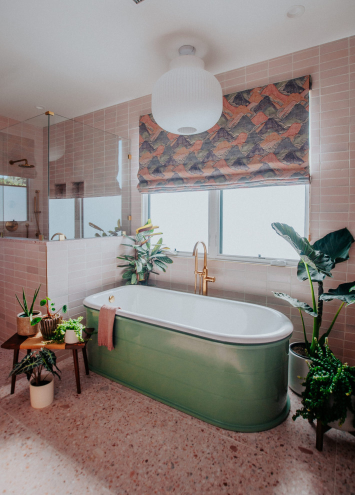 Bathroom - large mid-century modern master pink tile and ceramic tile terrazzo floor, pink floor and double-sink bathroom idea in Los Angeles with flat-panel cabinets, medium tone wood cabinets, pink walls, terrazzo countertops, a hinged shower door, pink countertops and a built-in vanity