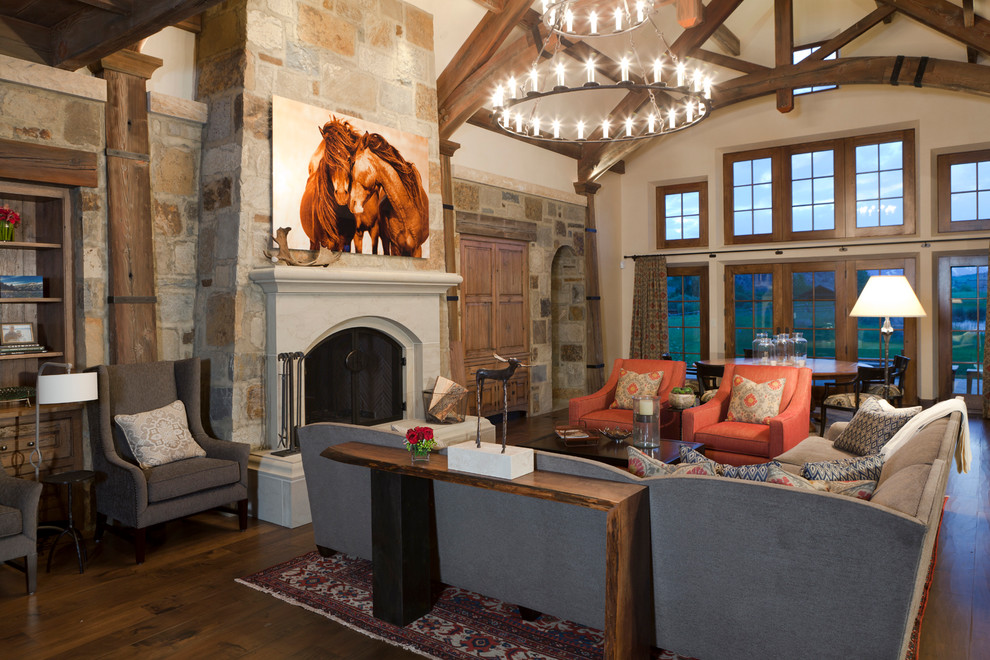 Living room - large rustic open concept living room idea in Other with a standard fireplace and a stone fireplace