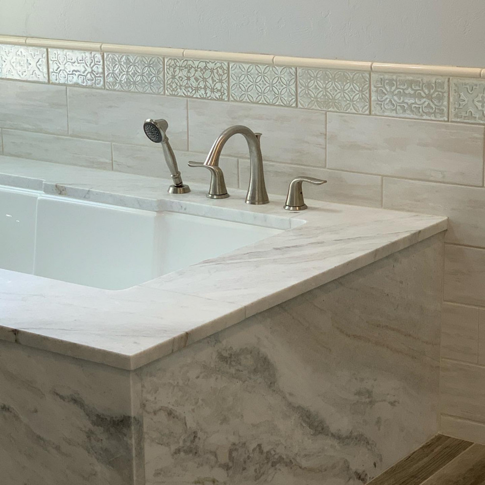 Example of a large eclectic master gray tile and porcelain tile porcelain tile, multicolored floor and double-sink doorless shower design in Phoenix with raised-panel cabinets, gray cabinets, an undermount tub, a one-piece toilet, gray walls, an undermount sink, marble countertops, white countertops and a built-in vanity