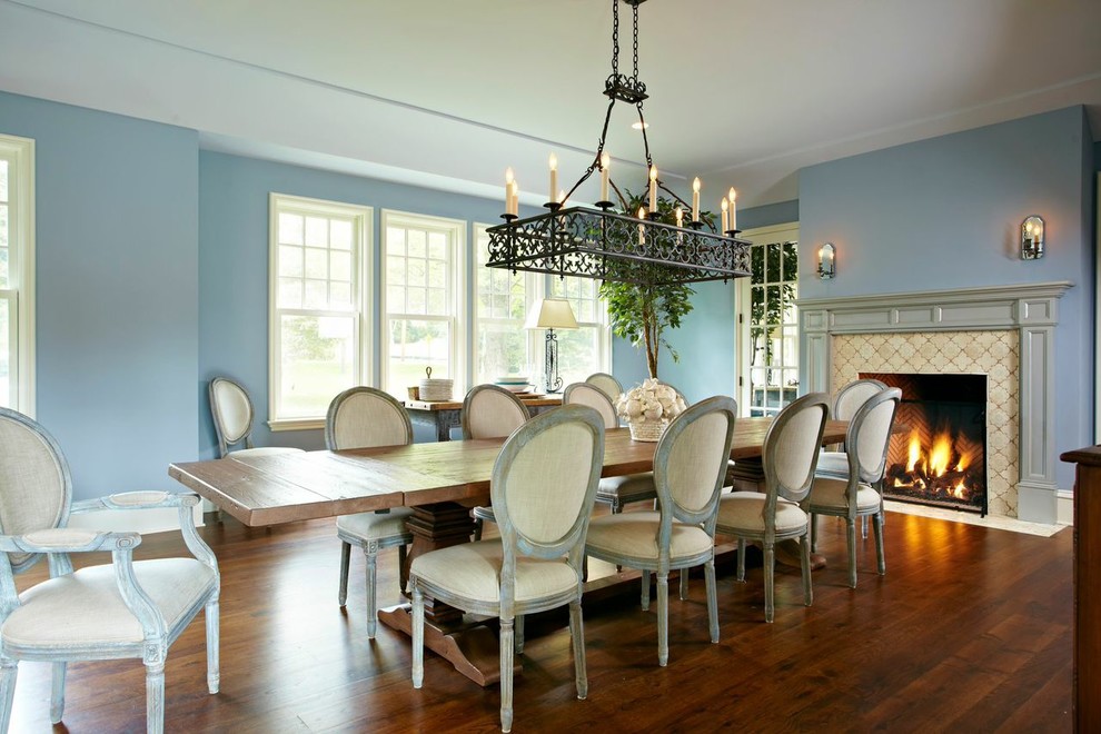 Inspiration for a dining room in New York with blue walls and dark hardwood floors.