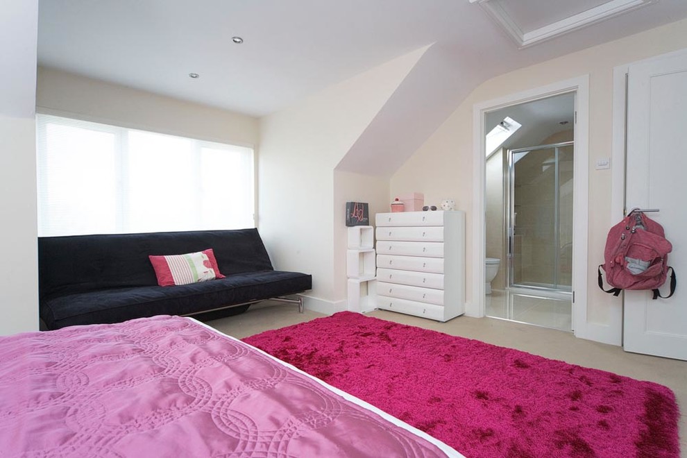 This is an example of a mid-sized contemporary kids' room for girls in Dublin with white walls and carpet.