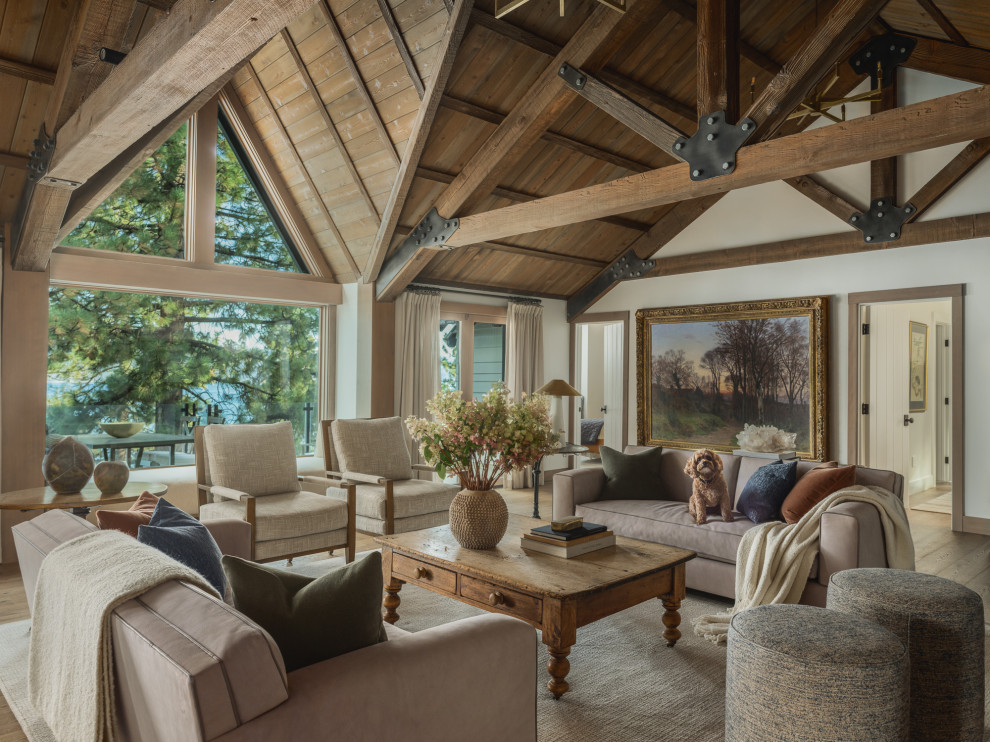 Inspiration for a large rustic open concept medium tone wood floor, brown floor and exposed beam living room remodel with white walls, a standard fireplace and a stone fireplace