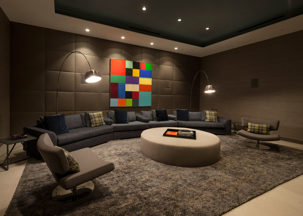 Large modern enclosed home theatre in Los Angeles with grey walls.