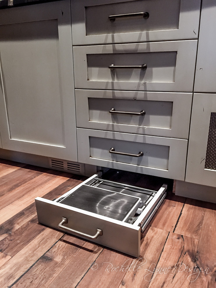 Mountain style u-shaped medium tone wood floor kitchen pantry photo in Calgary with shaker cabinets and distressed cabinets