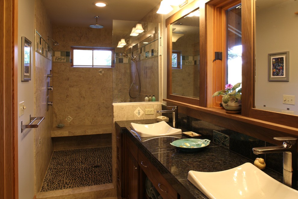 Large arts and crafts master bathroom in Portland with a vessel sink, flat-panel cabinets, dark wood cabinets, tile benchtops, an open shower, a one-piece toilet, beige walls, ceramic floors, pebble tile, brown tile, beige floor and an open shower.