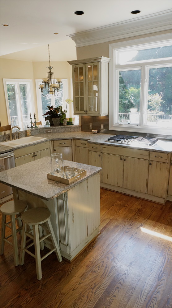 Large mountain style u-shaped medium tone wood floor eat-in kitchen photo in Atlanta with an undermount sink, flat-panel cabinets, distressed cabinets, quartz countertops, white backsplash, ceramic backsplash, stainless steel appliances and beige walls