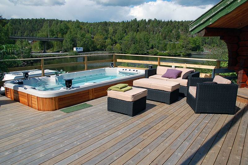 Inspiration for a mid-sized country backyard rectangular aboveground pool in Orange County with a hot tub and decking.