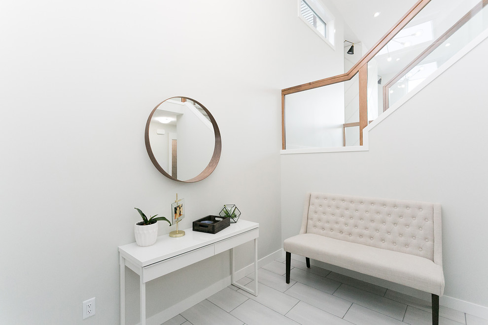 Inspiration for a mid-sized modern foyer with white walls, a single front door, a gray front door and white floor.