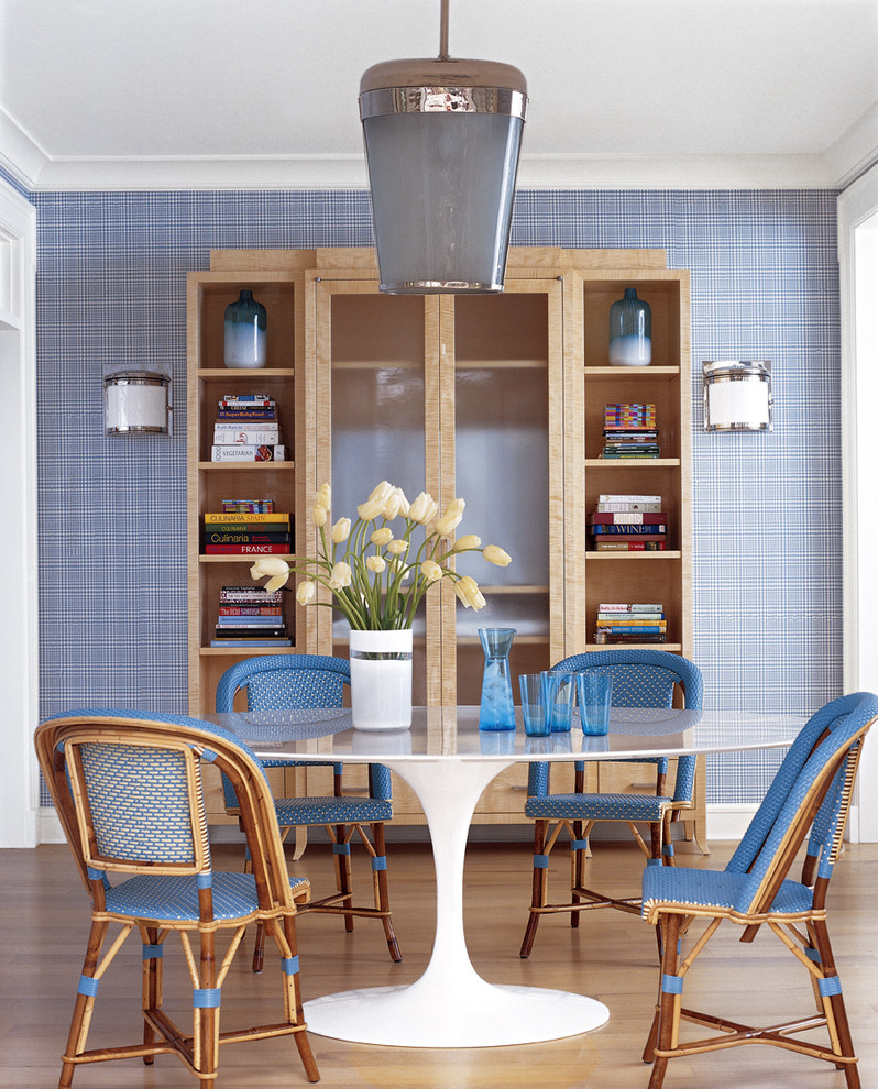 Contemporary dining room in New York with blue walls and medium hardwood floors.