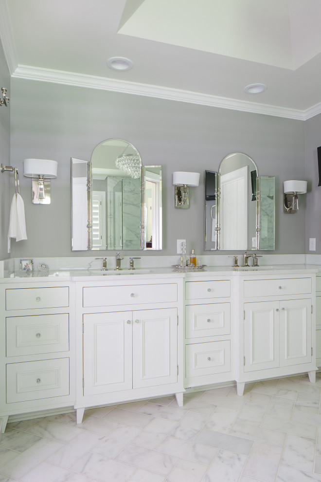 Inspiration for a large classic ensuite bathroom in Atlanta with freestanding cabinets, white cabinets, a corner shower, a two-piece toilet, white tiles, marble tiles, grey walls, marble flooring, a submerged sink, marble worktops, white floors, a hinged door, white worktops, a wall niche, double sinks, a built in vanity unit and a drop ceiling.