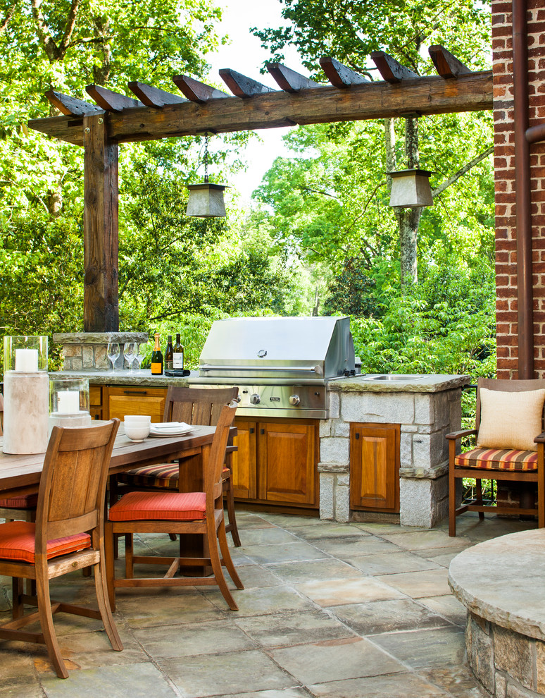 Patio - large transitional backyard concrete paver patio idea in Atlanta with a roof extension and a bbq area