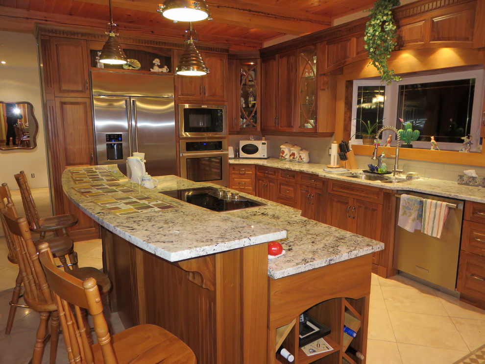 Large transitional l-shaped ceramic tile open concept kitchen photo with raised-panel cabinets, medium tone wood cabinets, granite countertops, stainless steel appliances, an island, a double-bowl sink, white backsplash and subway tile backsplash