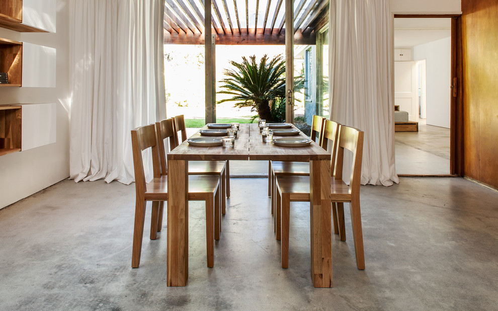Inspiration for a mid-sized contemporary kitchen/dining combo in Los Angeles with white walls and concrete floors.