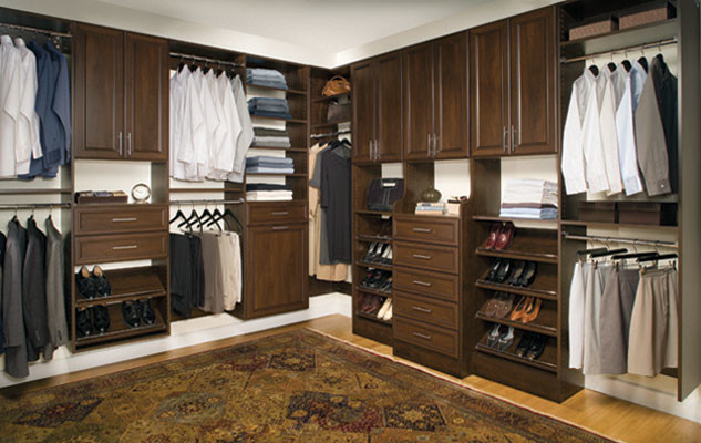 Design ideas for a mid-sized traditional gender-neutral walk-in wardrobe in Nashville with raised-panel cabinets, medium wood cabinets and light hardwood floors.