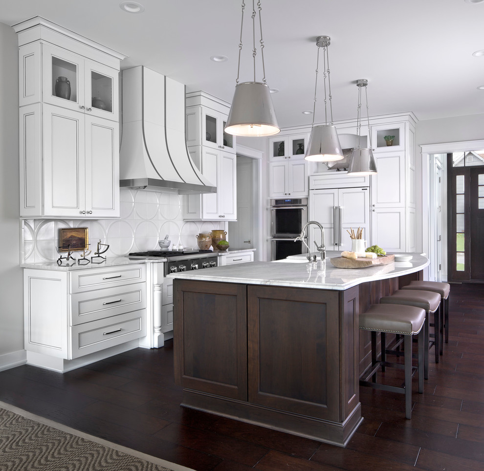 Photo of a traditional kitchen in Other with recessed-panel cabinets, white cabinets, granite benchtops, stainless steel appliances, dark hardwood floors, white splashback and with island.