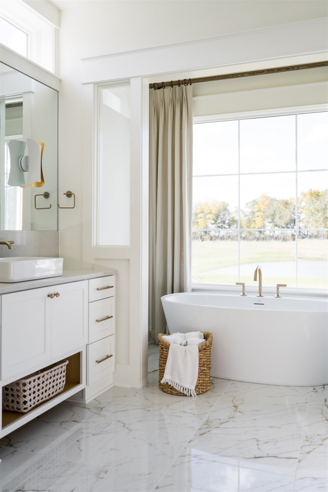 Design ideas for a mid-sized beach style master bathroom in Indianapolis with shaker cabinets, white cabinets, a corner tub, a shower/bathtub combo, white walls, marble floors, a vessel sink, engineered quartz benchtops, white benchtops, a double vanity and a built-in vanity.