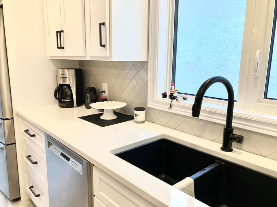 Inspiration for a mid-sized transitional galley ceramic tile and gray floor enclosed kitchen remodel with a double-bowl sink, shaker cabinets, white cabinets, quartz countertops, gray backsplash, ceramic backsplash, stainless steel appliances, an island and white countertops
