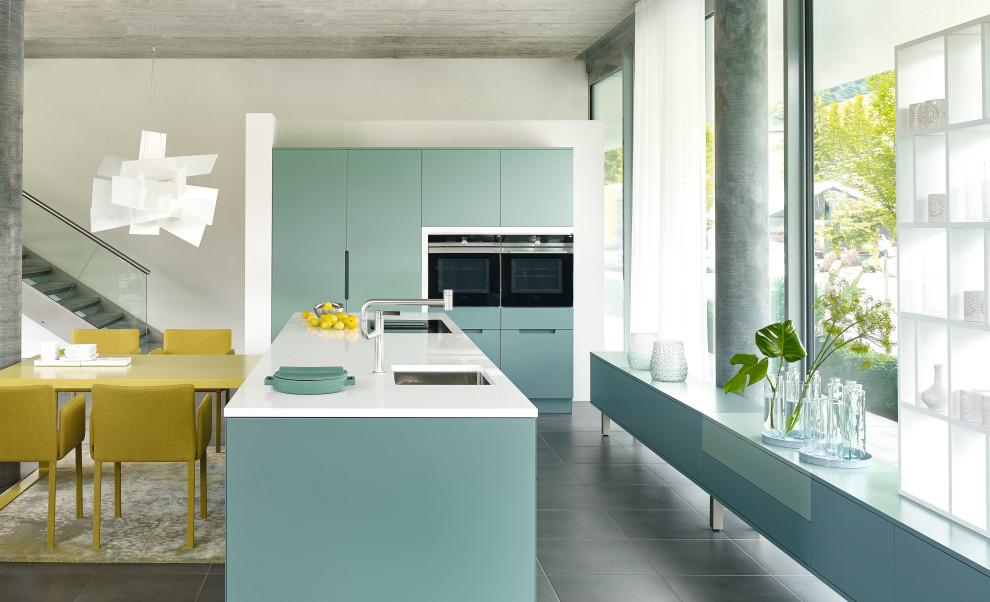 Photo of a mid-sized modern single-wall kitchen in Other with a single-bowl sink, beaded inset cabinets, blue cabinets, quartzite benchtops, black appliances, ceramic floors, with island, grey floor and white benchtop.