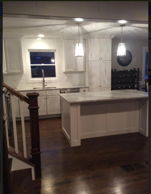 Transitional kitchen photo in Chicago with shaker cabinets, white cabinets, marble countertops and an island
