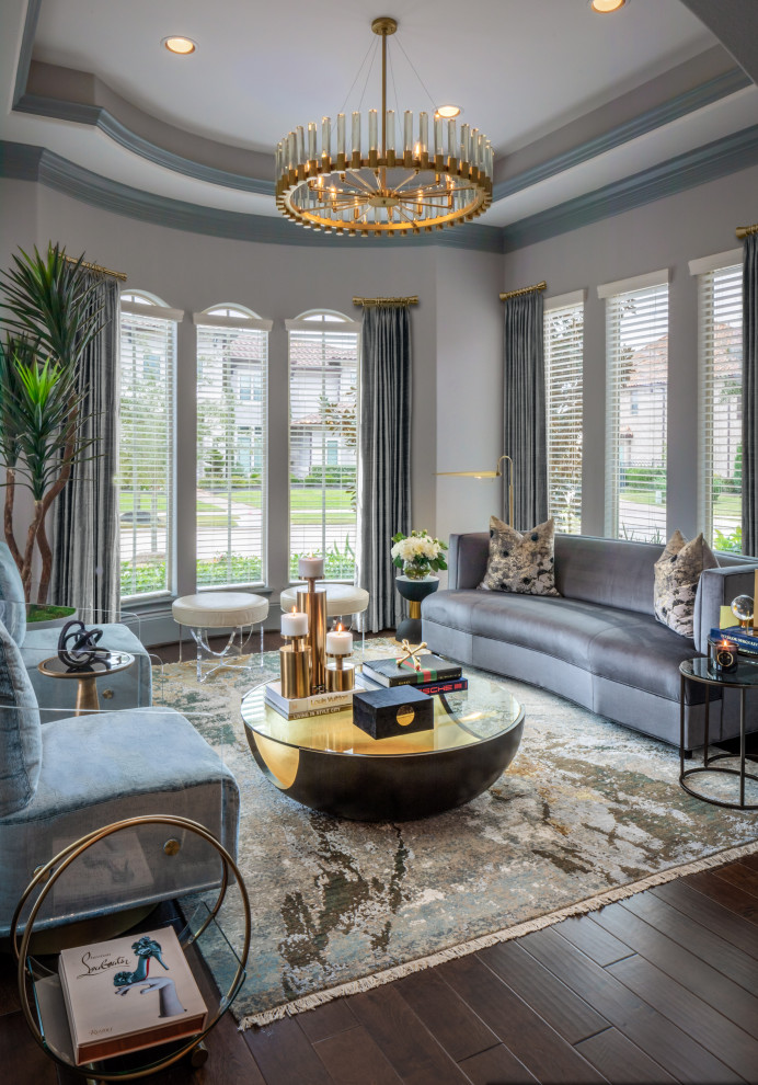 This is an example of a mid-sized contemporary formal enclosed living room in Houston with grey walls, dark hardwood floors, no fireplace, no tv, brown floor and recessed.