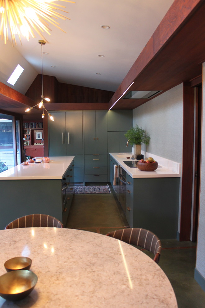 Inspiration for a midcentury galley eat-in kitchen in San Francisco with an integrated sink, flat-panel cabinets, green cabinets, quartz benchtops, white splashback, panelled appliances, concrete floors and with island.