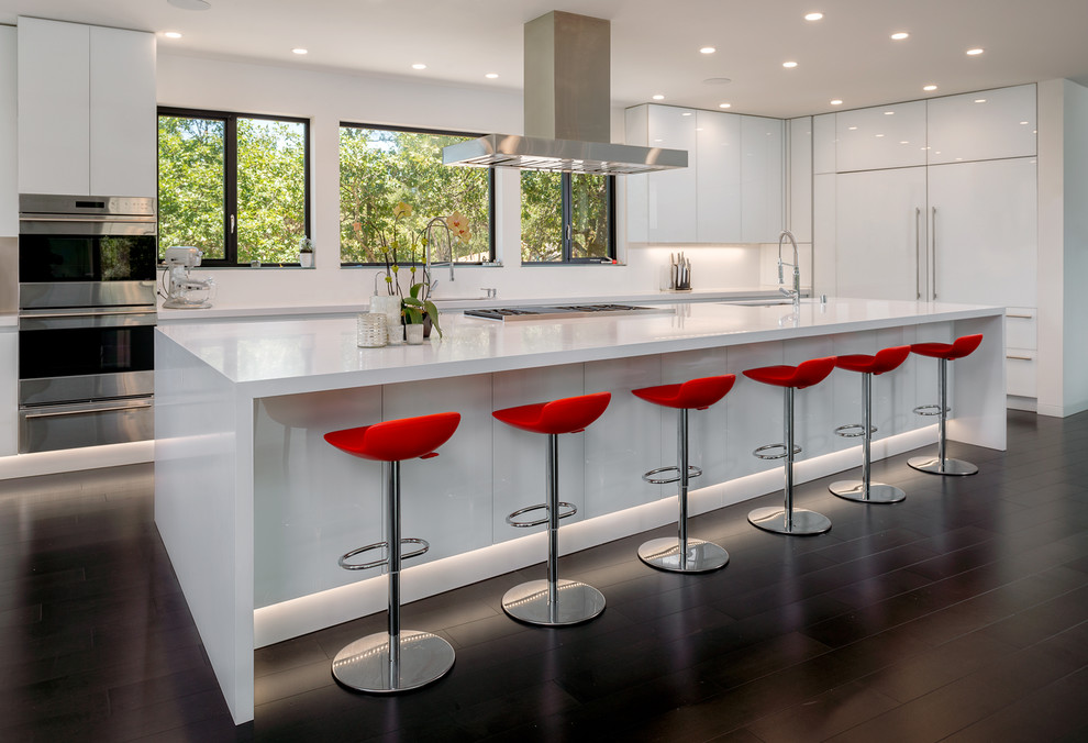 Example of a trendy dark wood floor kitchen design in San Francisco with flat-panel cabinets, white cabinets, white backsplash, paneled appliances and an island