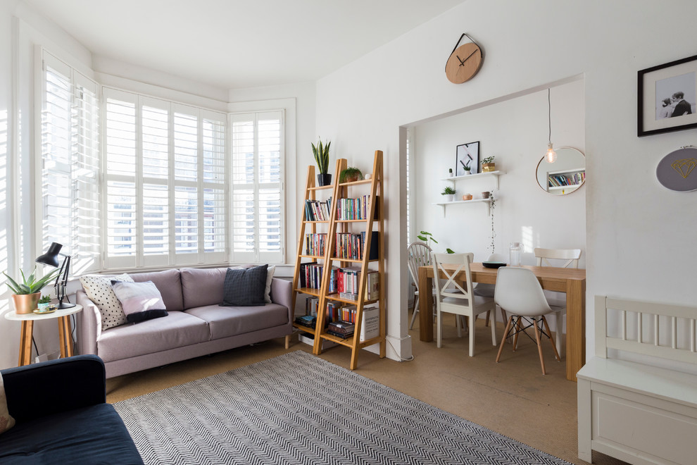 Design ideas for a scandinavian living room in London with white walls.