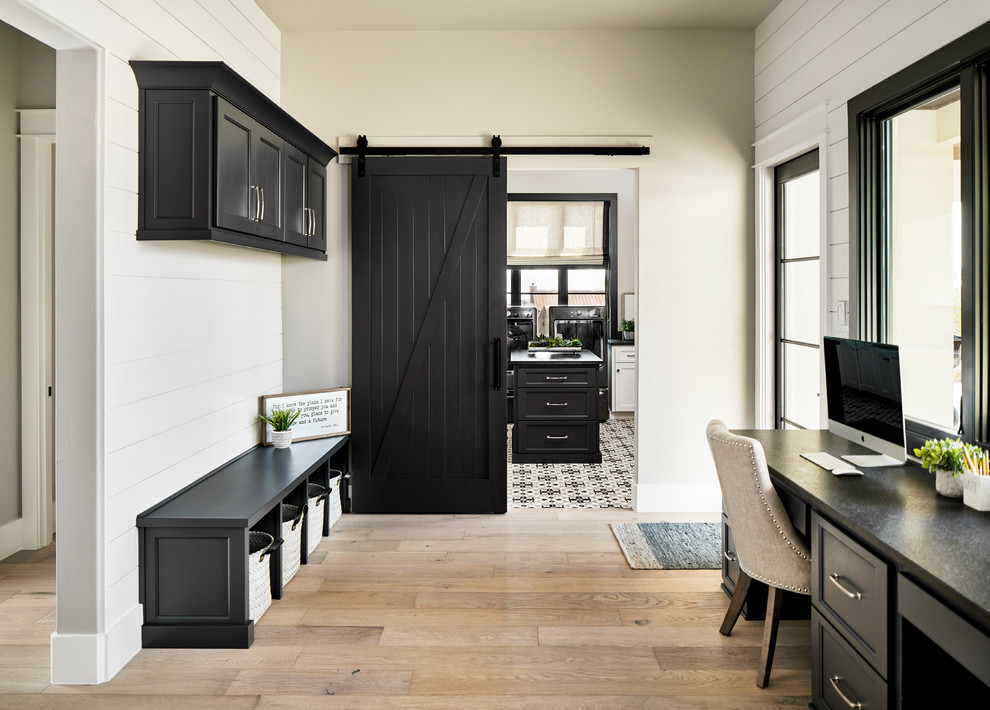 Mudroom - transitional light wood floor and beige floor mudroom idea with white walls and a glass front door