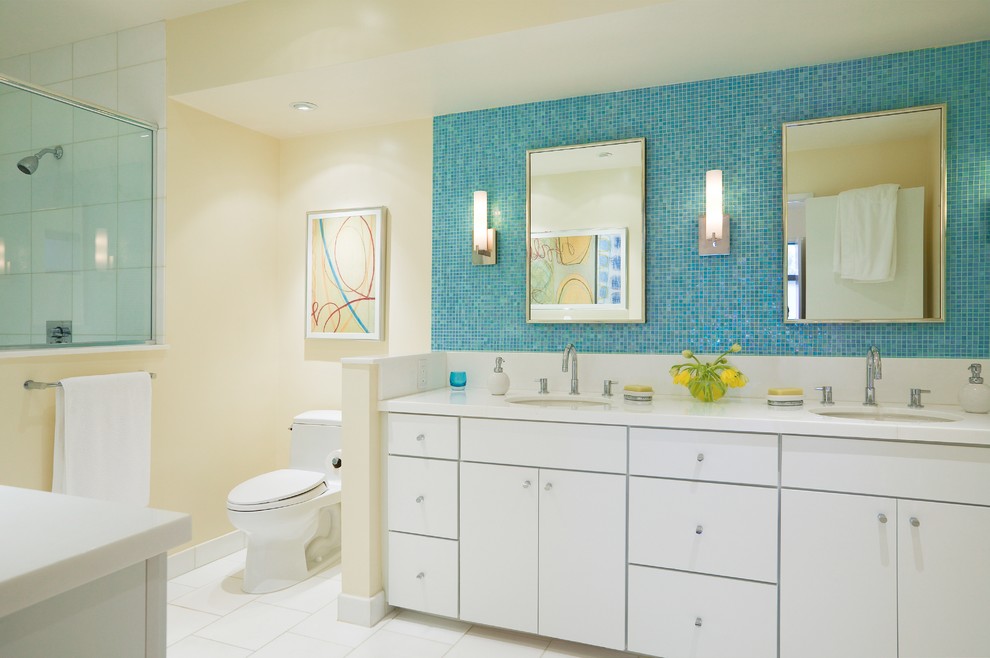 Inspiration for a contemporary bathroom in San Francisco with flat-panel cabinets, white cabinets, a one-piece toilet, blue tile and mosaic tile.