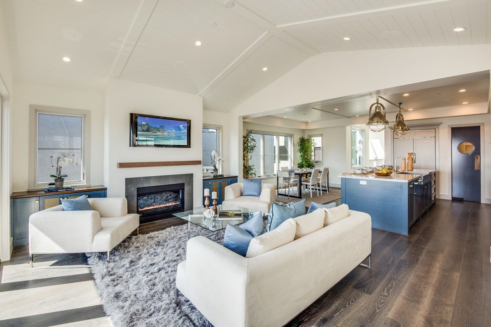 Design ideas for a beach style open concept living room in Los Angeles with white walls, dark hardwood floors and a ribbon fireplace.