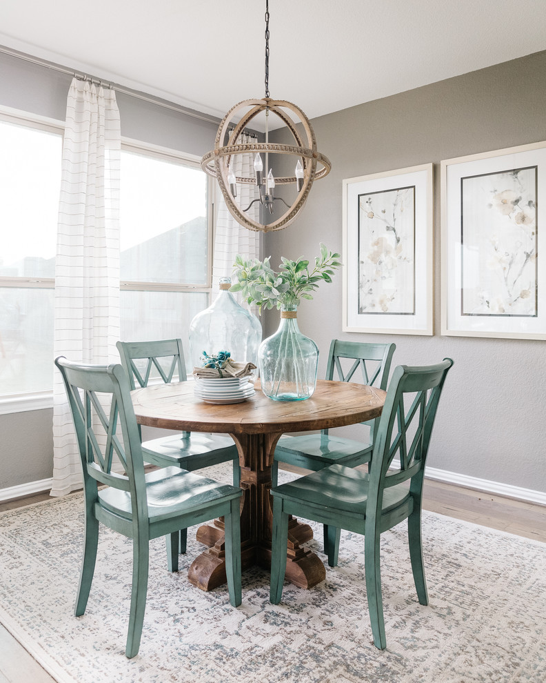 This is an example of a small beach style dining room in Houston with grey walls, light hardwood floors and no fireplace.