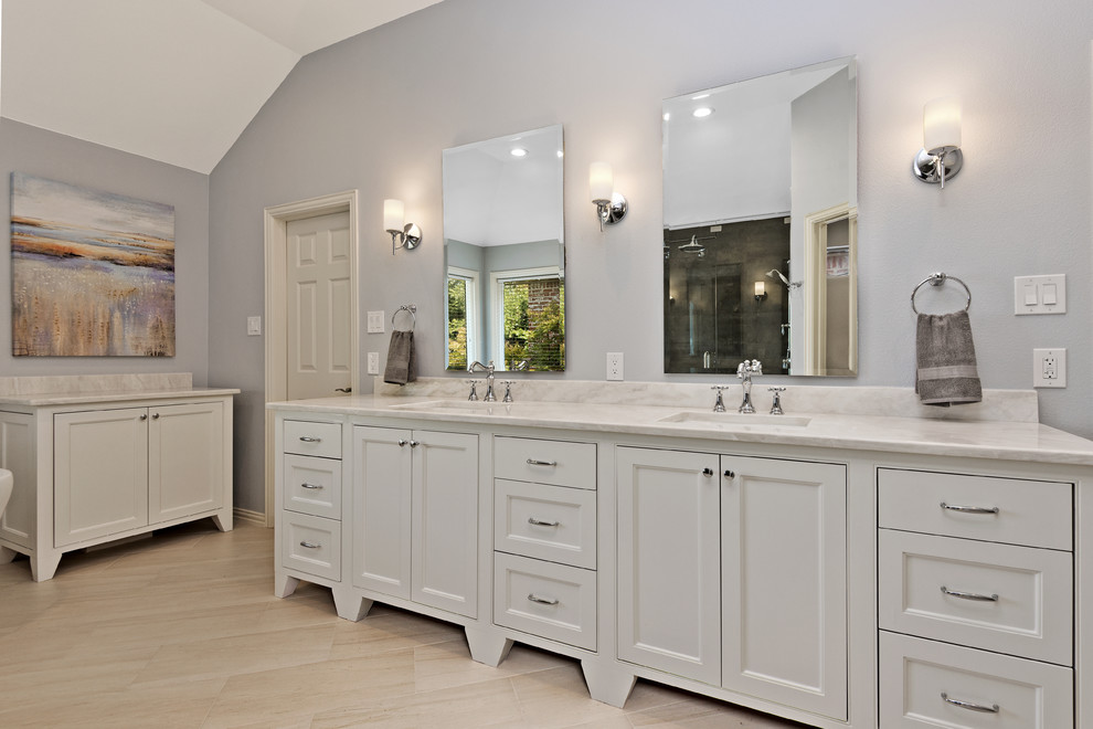 Design ideas for a mid-sized transitional master bathroom in Dallas with recessed-panel cabinets, white cabinets, blue walls, porcelain floors, an undermount sink and marble benchtops.