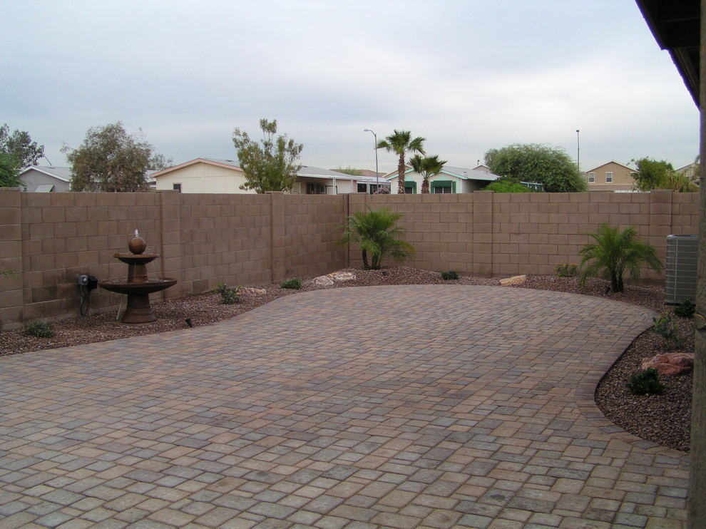 This is an example of a mid-sized traditional backyard full sun outdoor sport court in Phoenix with concrete pavers.