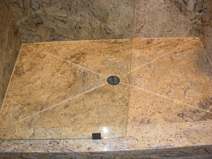 Example of a mid-sized white tile bathroom design with recessed-panel cabinets, medium tone wood cabinets and granite countertops