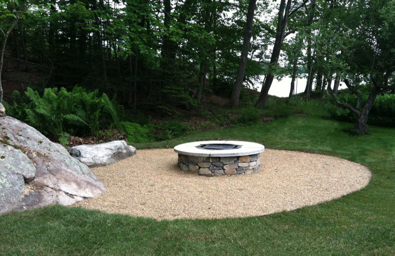 Mid-sized traditional backyard patio in Portland Maine with a fire feature, gravel and no cover.