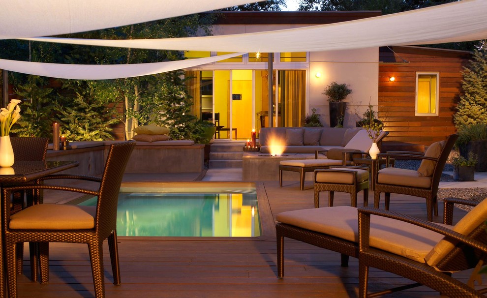 Inspiration for a contemporary rectangular pool in Denver with decking.