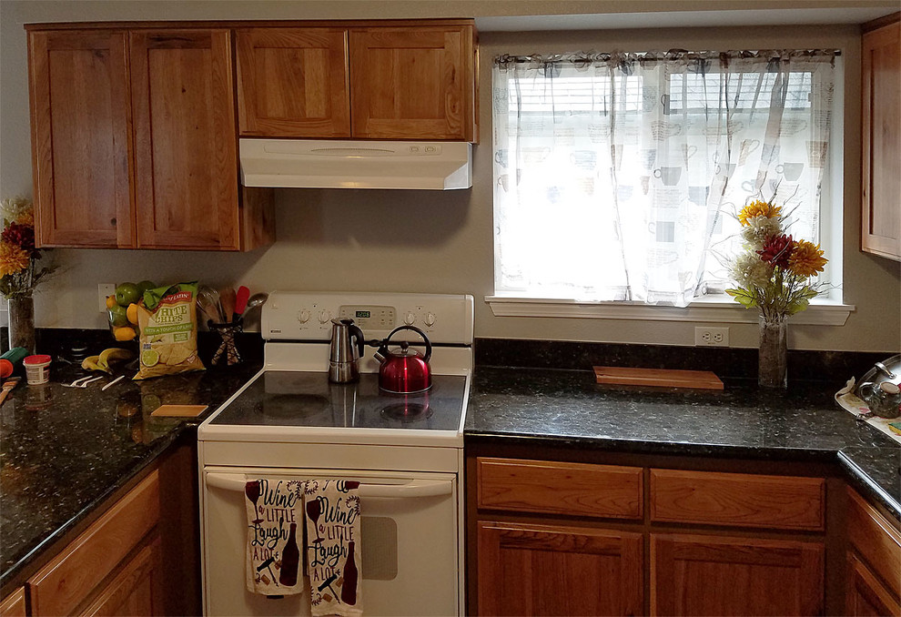 Inspiration for a large u-shaped brown floor kitchen remodel with shaker cabinets and no island