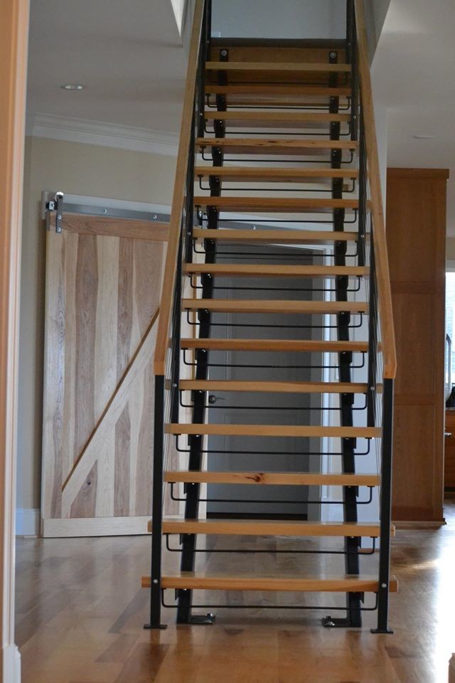 Inspiration for a large contemporary wood straight staircase in New York with open risers.