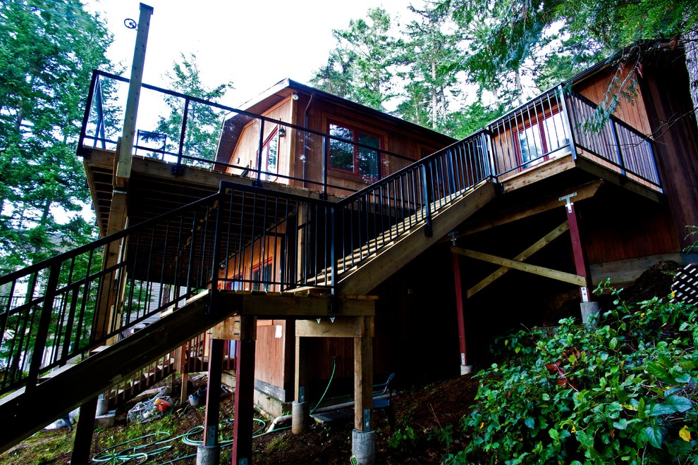 Deck - mid-sized rustic backyard balcony deck idea with no cover