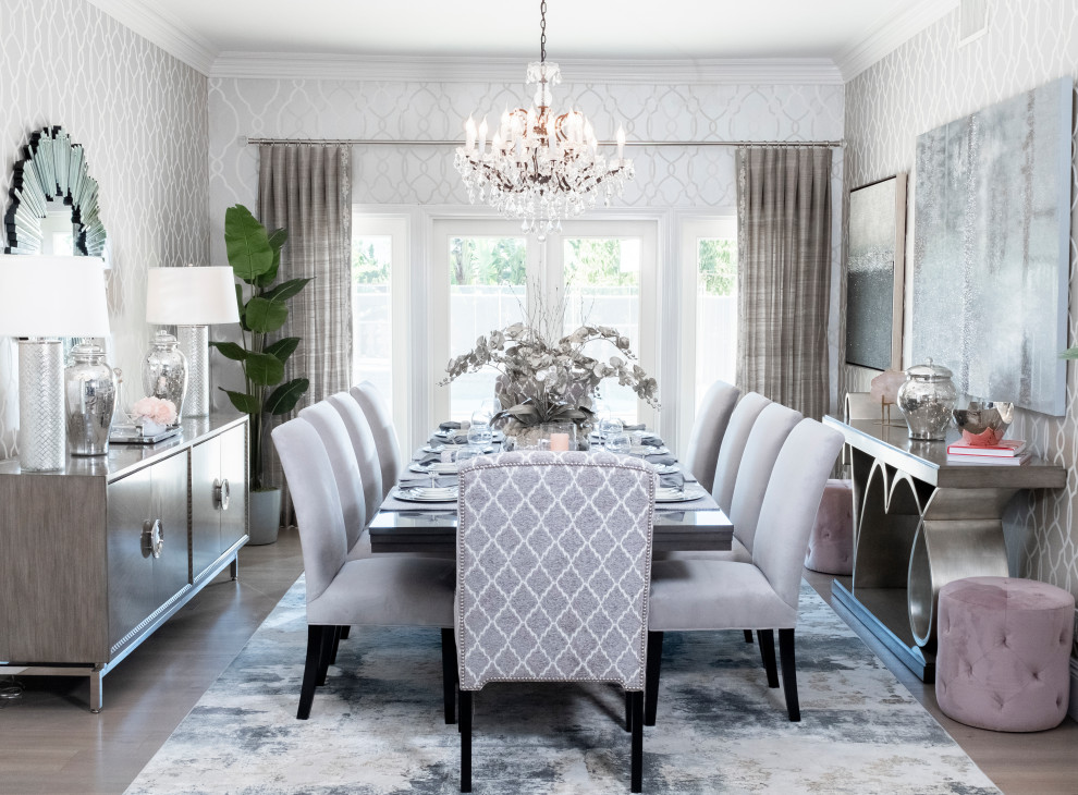 This is an example of a large contemporary separate dining room in Orange County with metallic walls, light hardwood floors, no fireplace, vaulted and wallpaper.