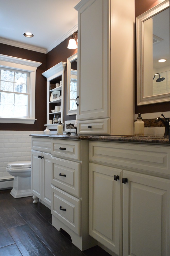 Traditional bathroom in New York with an undermount sink, furniture-like cabinets, white cabinets, marble benchtops, an alcove tub, an alcove shower, ceramic tile, brown walls and ceramic floors.