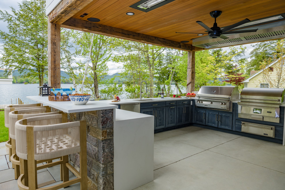 Patio kitchen - large coastal stone patio kitchen idea in Boston