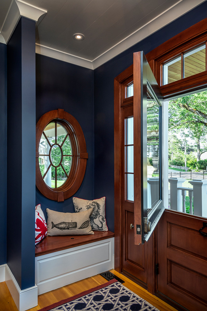Photo of a mid-sized beach style foyer in Boston with blue walls, light hardwood floors, a dutch front door, a medium wood front door and beige floor.