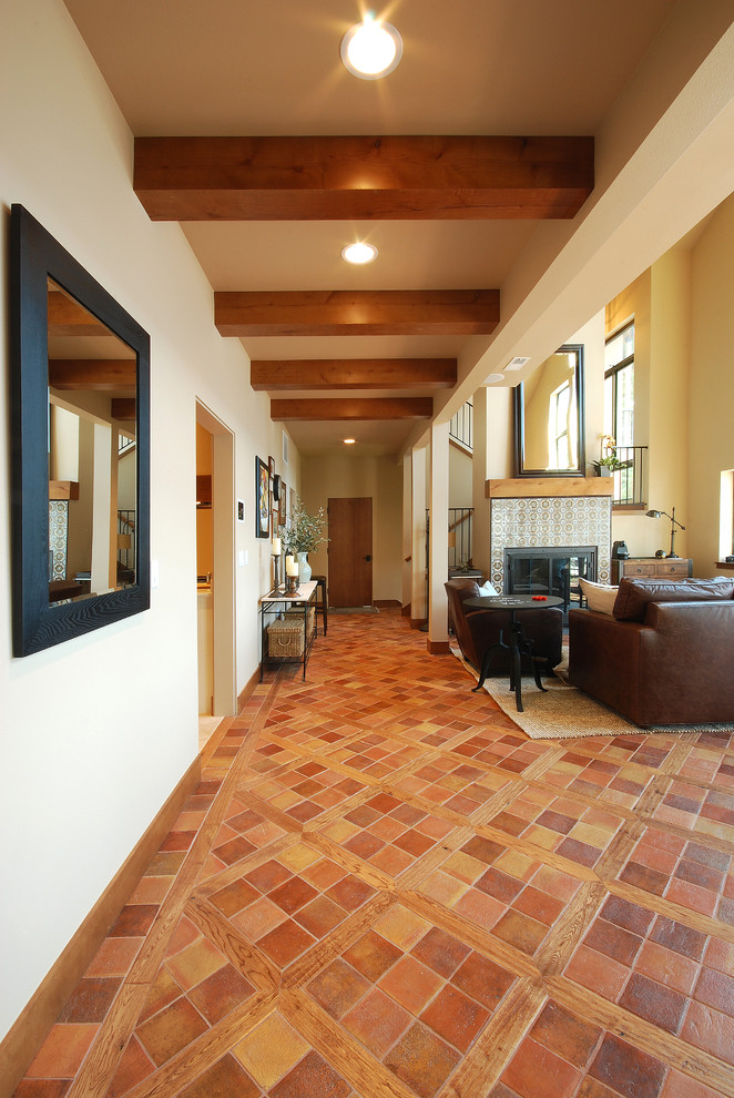 This is an example of a mid-sized mediterranean hallway in Seattle with white walls and ceramic floors.