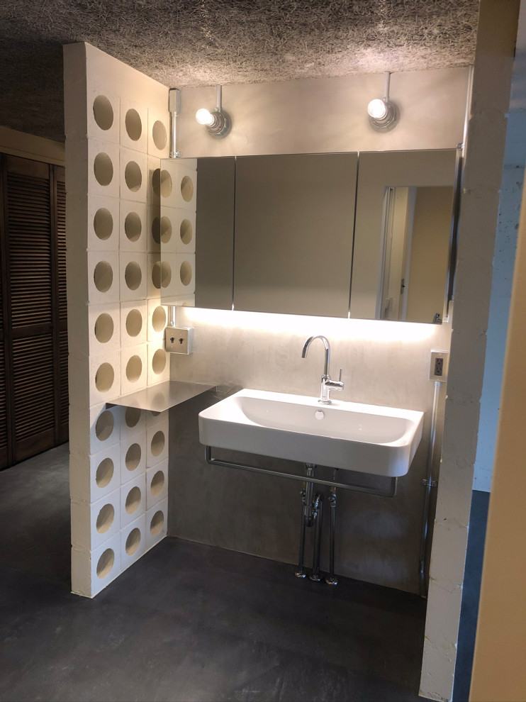 Photo of a small modern cloakroom in Tokyo with white cabinets, grey tiles, cement tiles, grey walls, concrete flooring, a wall-mounted sink, stainless steel worktops, grey floors, a freestanding vanity unit, a timber clad ceiling and tongue and groove walls.